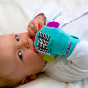 A baby enjoying chewing on the side teethers on our Gummee Glove