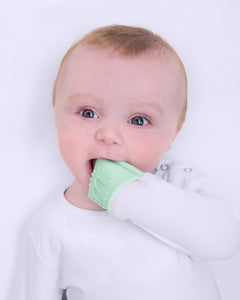 Baby chewing on their built in foldable teething mitts